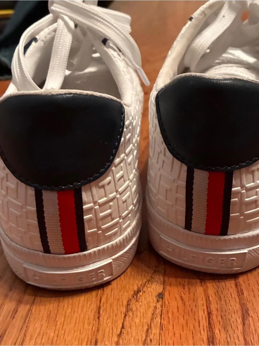 Tommy Hilfiger White Embossed Sneakers with Navy Heel and Red-White-Blue Stripe.
